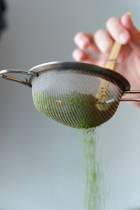 Sifted matcha preparation before whisking for smoother foam and texture.