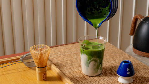A Forest Cloud matcha ritual setup with whisked matcha being poured into a cup.